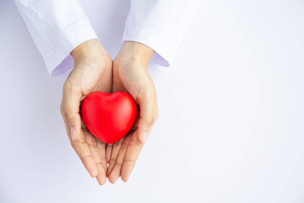 A pair of hands holding a heart