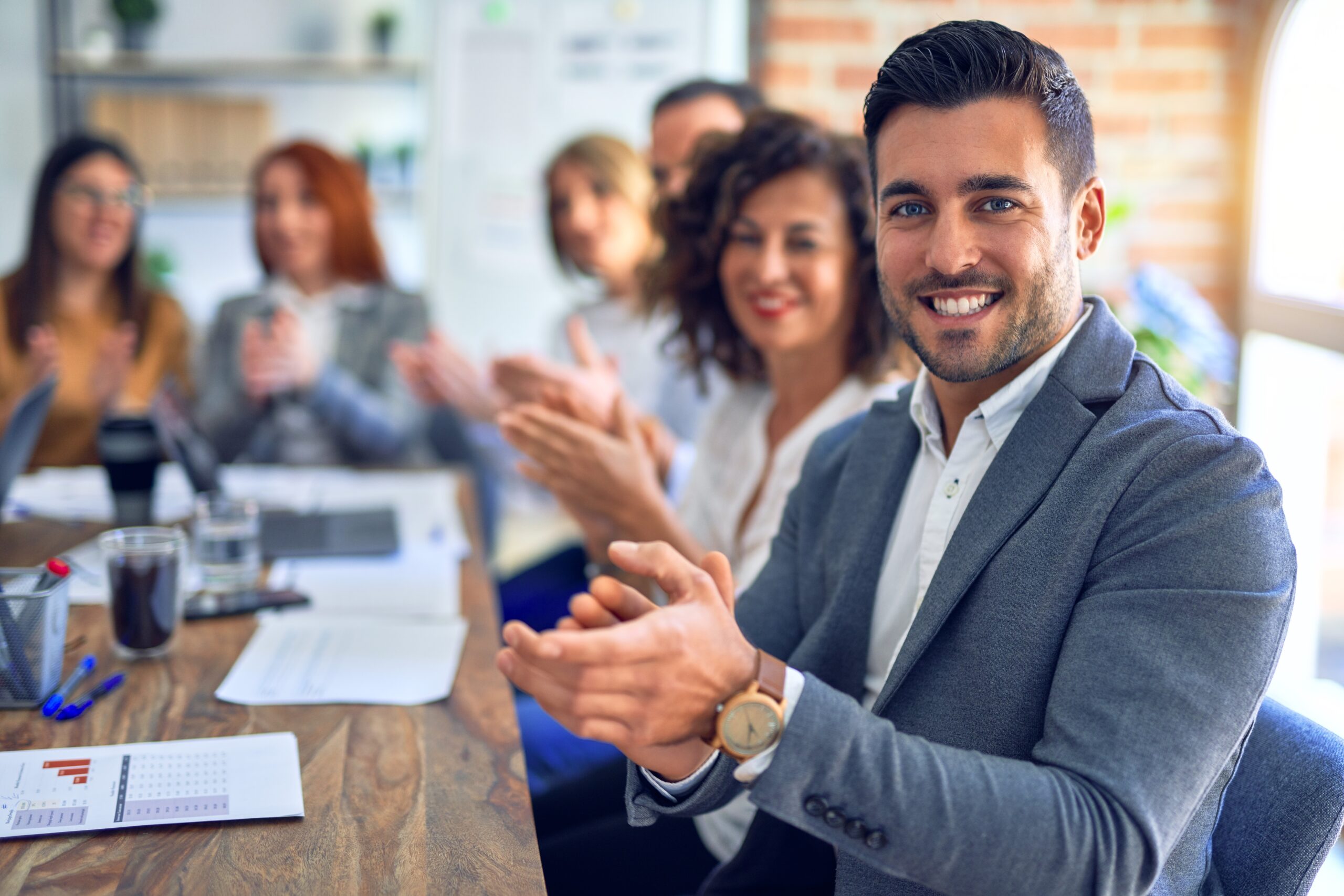 People in a staff meeting applauding